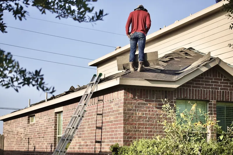 Professional roofer working on a residential roof in Holiday
